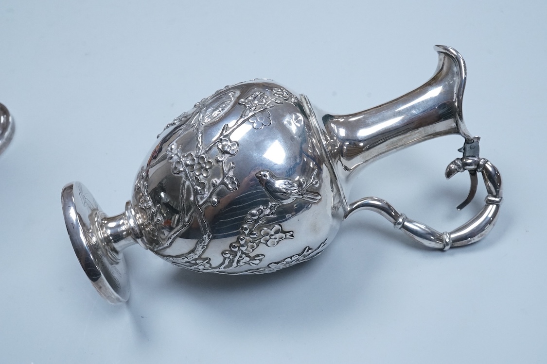 An early 20th century Chinese Export white metal posy vase, by Wang Hing, 18.4cm and a similar ewer by Tien Shing?, lacking cover.